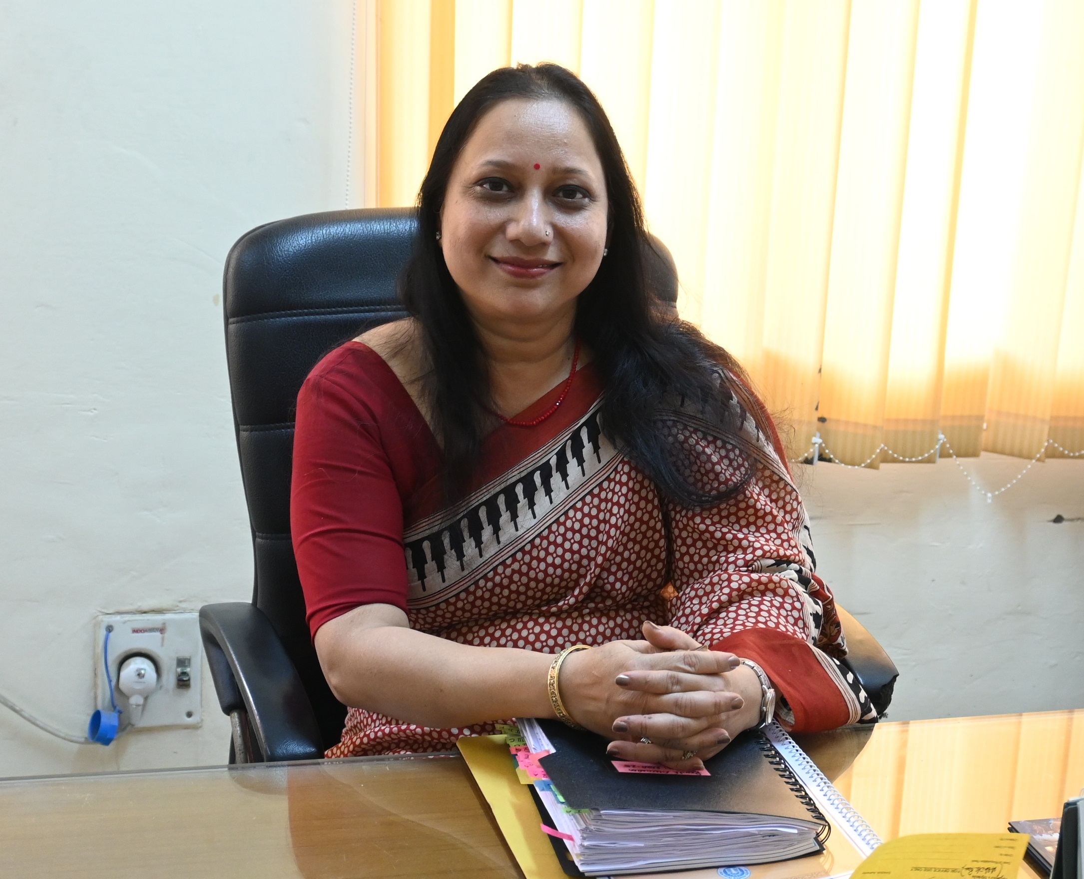 Photo of Mrs. Anuja Mittal, the Middle school incharge, sitting in her office.